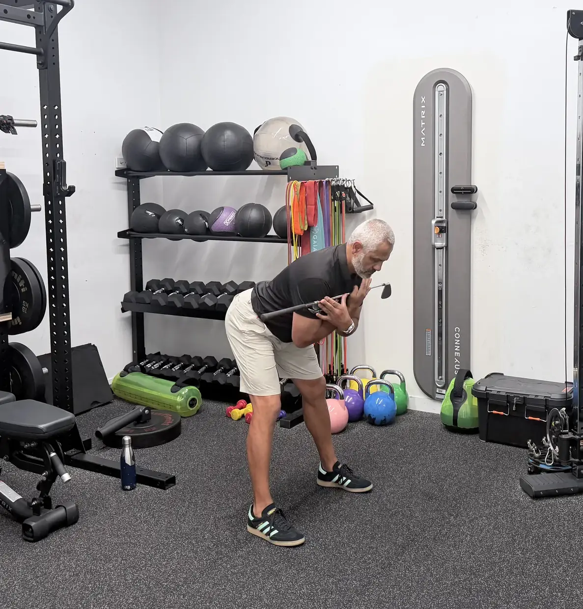 Hinged forward from the hips with a golf club held at the chest and a small bend in the knees