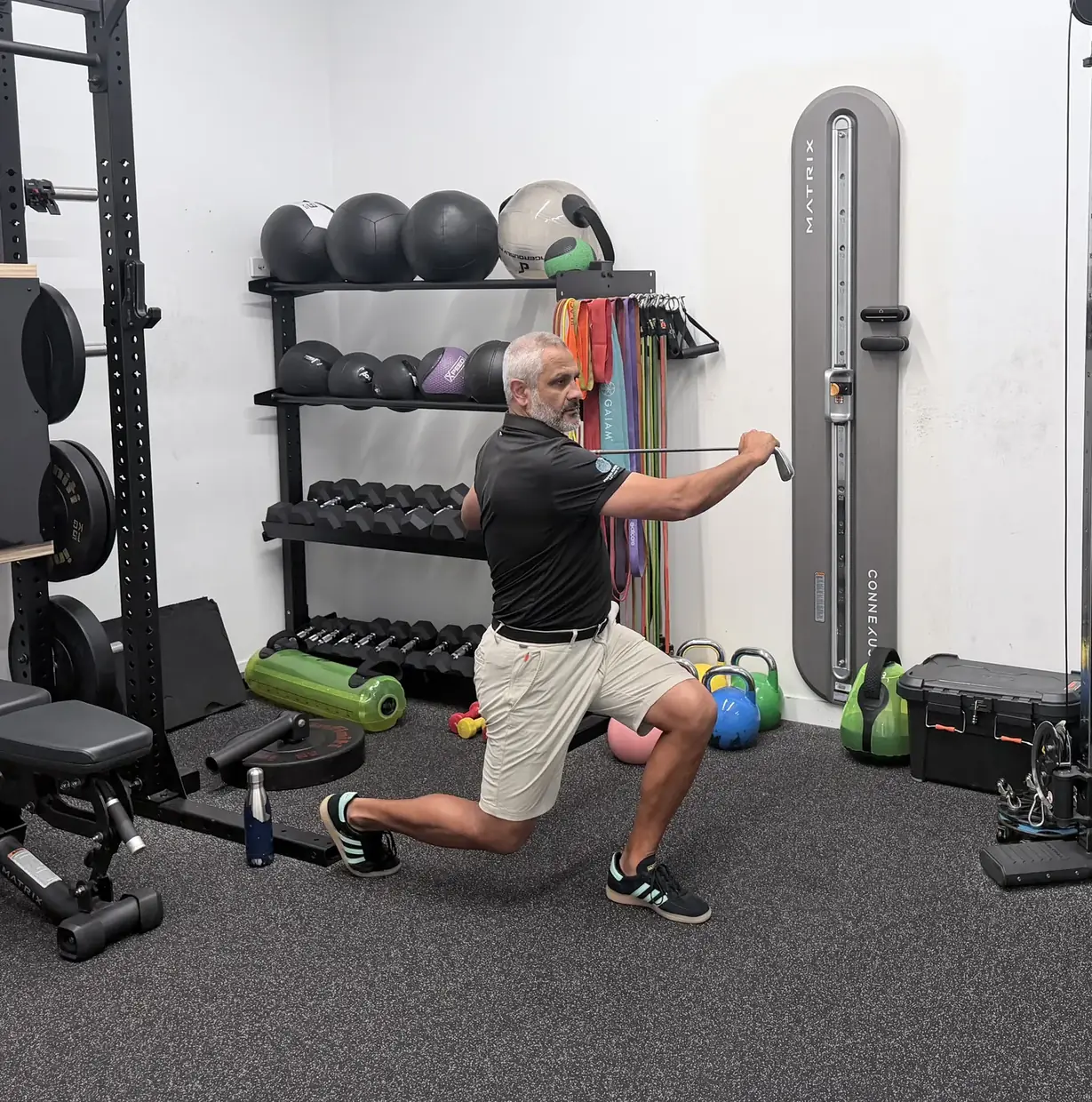 A reverse lunge with the club and chest rotated towards the front leg