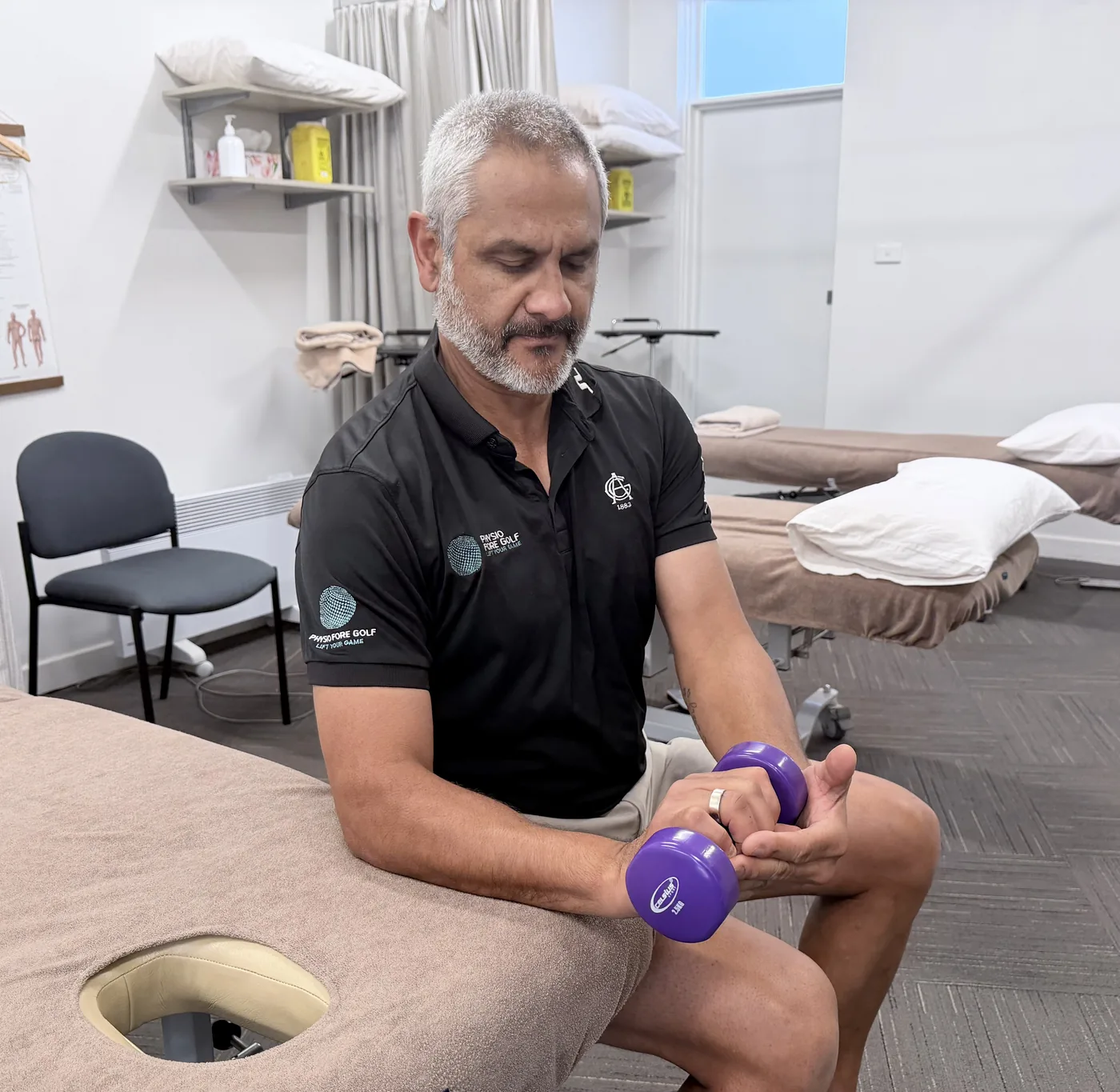 The start position of eccentric wrist flexion, the opposite hand helping lift the loaded wrist upwards