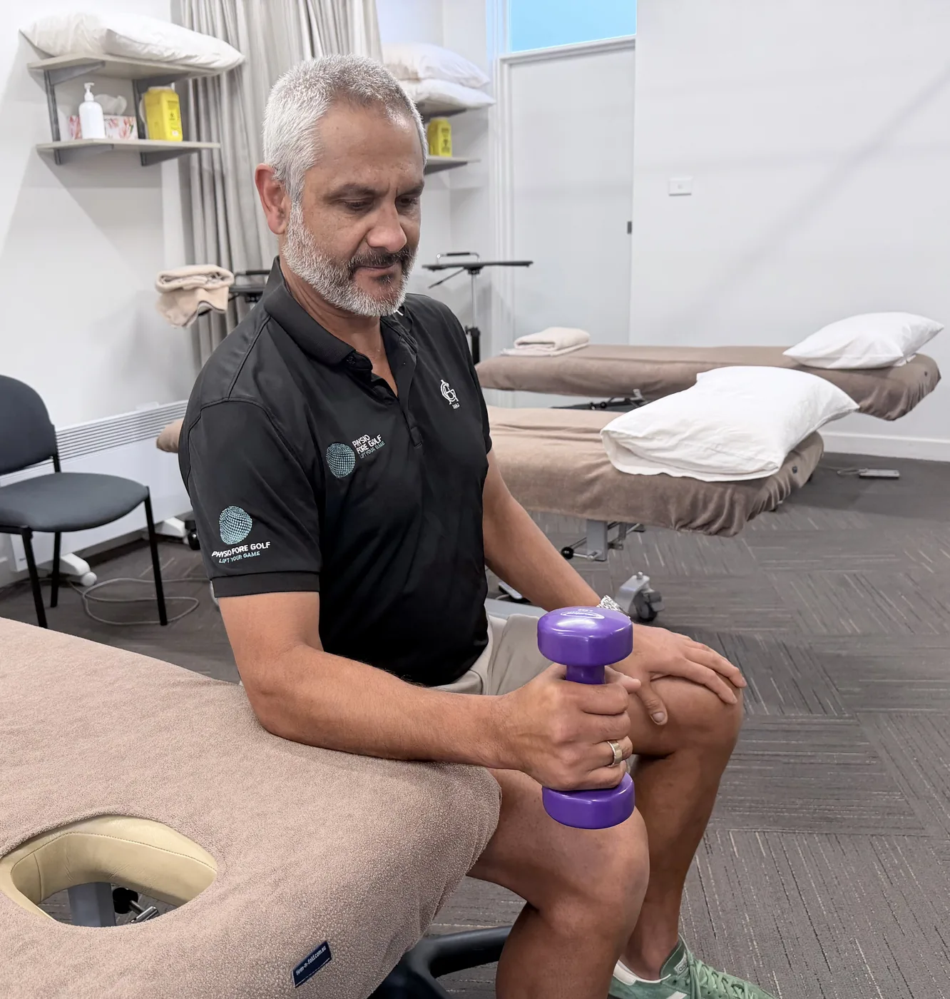 The neutral start position for forearm rotation, elbow bent to ninety degrees with the dumbbell held vertically and the palm facing sideways